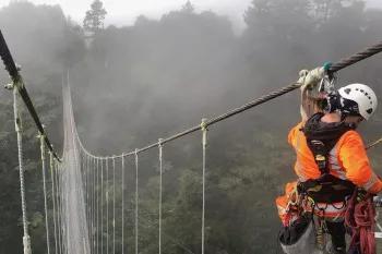 Avalon team member working on a wire swing bridge