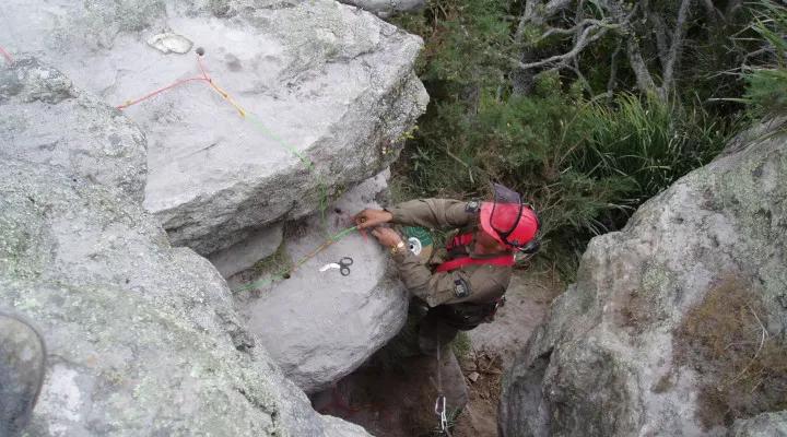 An Avalon technician installs blasting charges in rock