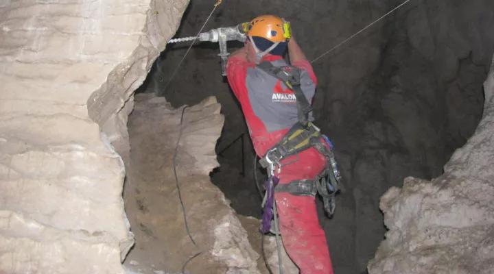 Avalon team member drilling limestone underground